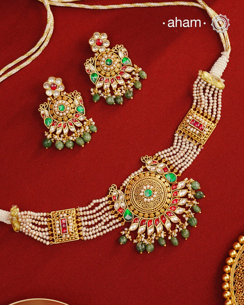 This Peacock Gold Polish Silver Choker Set is a beautiful traditional design crafted from 92.5 sterling silver and finished in gold polish. This stunning piece is further decorated with exquisite kundan and delicate pearl work. Perfect for weddings and festivities.
