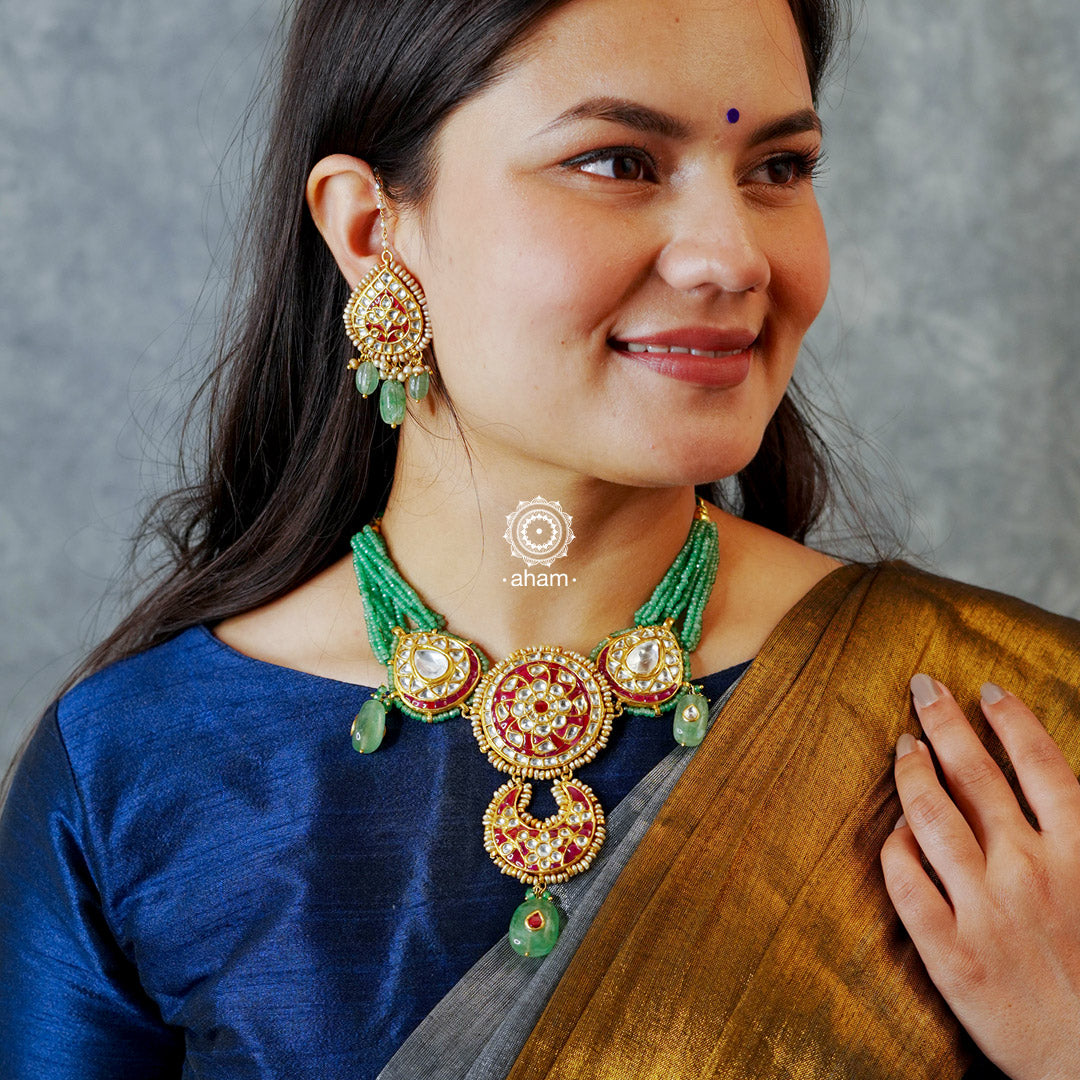 Make a sophisticated style statement this festive season with our beautiful gold polish neckpiece and earrings set. Crafted using traditional jadau kundan techniques in silver with semi precious beads and cultured pearls. Perfect for intimate weddings and upcoming festive celebrations.