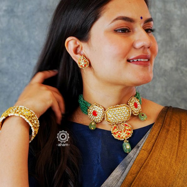 Make a sophisticated style statement this festive season with our beautiful gold polish  neckpiece and earrings set. Crafted using traditional jadau kundan techniques in silver with semi precious beads and cultured pearls. Perfect for intimate weddings and upcoming festive celebrations.