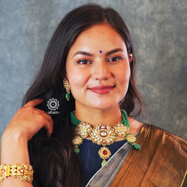 Make a sophisticated style statement this festive season with our beautiful gold polish parrot neckpiece and earrings set. Crafted using traditional jadau kundan techniques in silver with semi precious beads and cultured pearls. Perfect for intimate weddings and upcoming festive celebrations.