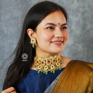 Make a sophisticated style statement this festive season with our beautiful gold polish neckpiece and earrings set. Crafted using traditional jadau kundan techniques in silver with semi precious beads and cultured pearls. Perfect for intimate weddings and upcoming festive celebrations.