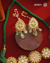 Make a sophisticated style statement this festive season with our beautiful gold polish neckpiece and earrings set. Crafted using traditional jadau kundan techniques in silver with semi precious beads and cultured pearls. The piece boast of the finest craftsmanship. Perfect for intimate weddings and upcoming festive celebrations.