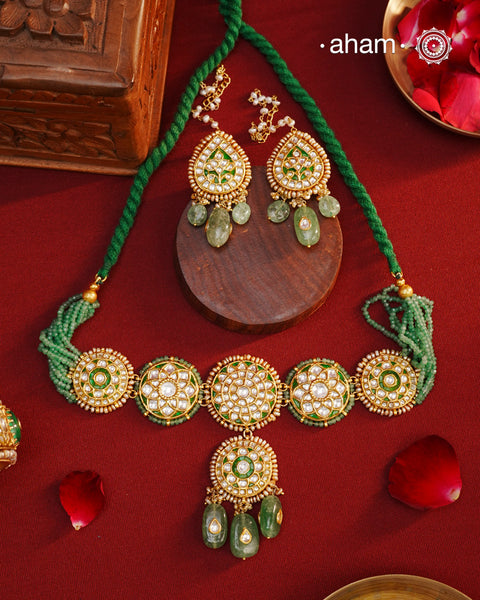 Make a sophisticated style statement this festive season with our beautiful gold polish neckpiece and earrings set. Crafted using traditional jadau kundan techniques in silver with semi precious beads and cultured pearls. The piece boast of the finest craftsmanship. Perfect for intimate weddings and upcoming festive celebrations.