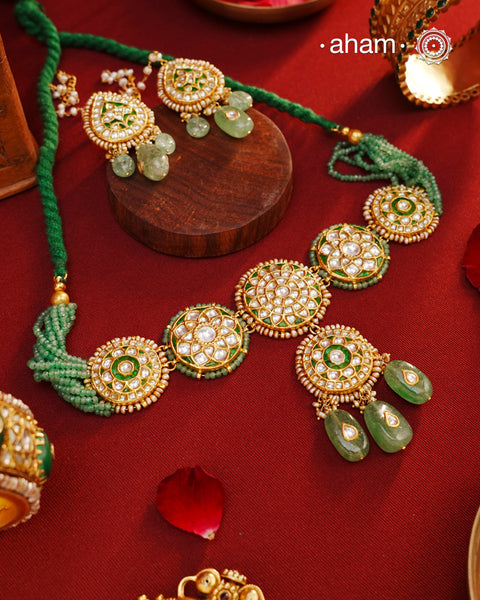 Make a sophisticated style statement this festive season with our beautiful gold polish neckpiece and earrings set. Crafted using traditional jadau kundan techniques in silver with semi precious beads and cultured pearls. The piece boast of the finest craftsmanship. Perfect for intimate weddings and upcoming festive celebrations.