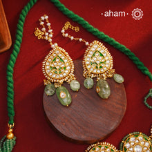 Make a sophisticated style statement this festive season with our beautiful gold polish neckpiece and earrings set. Crafted using traditional jadau kundan techniques in silver with semi precious beads and cultured pearls. The piece boast of the finest craftsmanship. Perfect for intimate weddings and upcoming festive celebrations.