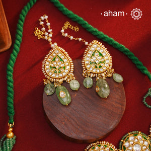 Make a sophisticated style statement this festive season with our beautiful gold polish neckpiece and earrings set. Crafted using traditional jadau kundan techniques in silver with semi precious beads and cultured pearls. The piece boast of the finest craftsmanship. Perfect for intimate weddings and upcoming festive celebrations.