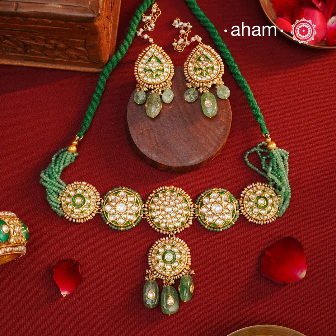 Make a sophisticated style statement this festive season with our beautiful gold polish neckpiece and earrings set. Crafted using traditional jadau kundan techniques in silver with semi precious beads and cultured pearls. The piece boast of the finest craftsmanship. Perfect for intimate weddings and upcoming festive celebrations.