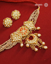 Make a style statement this festive season with our beautiful gold polish neckpiece and earrings set. Crafted using traditional jadau kundan techniques in silver with cultured pearls. Perfect for intimate weddings and upcoming festive celebrations.