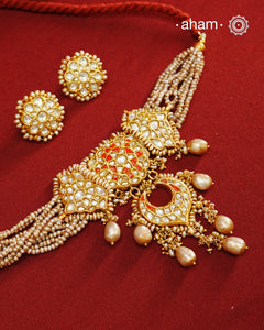 Make a style statement this festive season with our beautiful gold polish neckpiece and earrings set. Crafted using traditional jadau kundan techniques in silver with cultured pearls. Perfect for intimate weddings and upcoming festive celebrations.