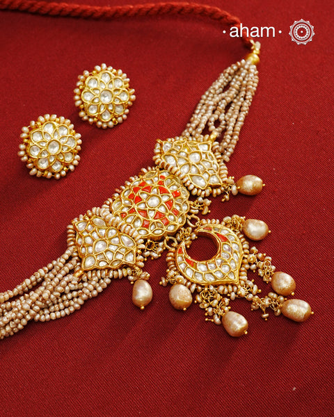 Make a style statement this festive season with our beautiful gold polish neckpiece and earrings set. Crafted using traditional jadau kundan techniques in silver with cultured pearls. Perfect for intimate weddings and upcoming festive celebrations.