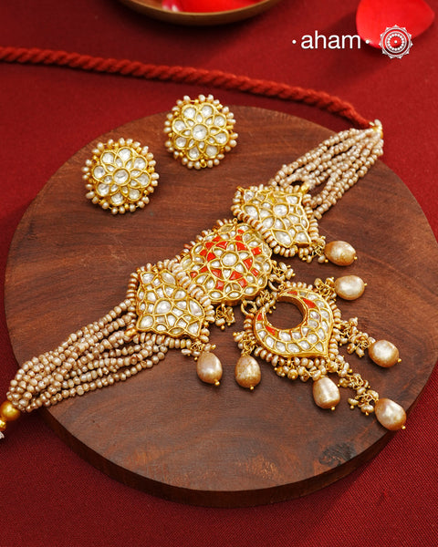 Make a style statement this festive season with our beautiful gold polish neckpiece and earrings set. Crafted using traditional jadau kundan techniques in silver with cultured pearls. Perfect for intimate weddings and upcoming festive celebrations.