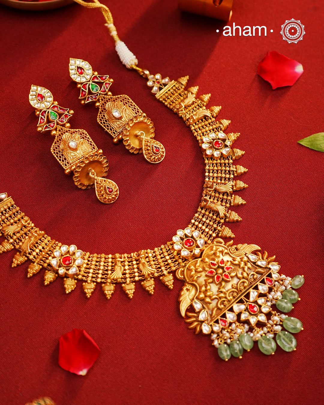 This Kundan Pearl Gold Polish Silver Neckpiece & Earrings Set from our Heritage collection showcases intricate traditional designs, meticulously crafted in 92.5 silver with a stunning gold polish and exquisite kundan work. Perfect for modern brides seeking a touch of timeless elegance.