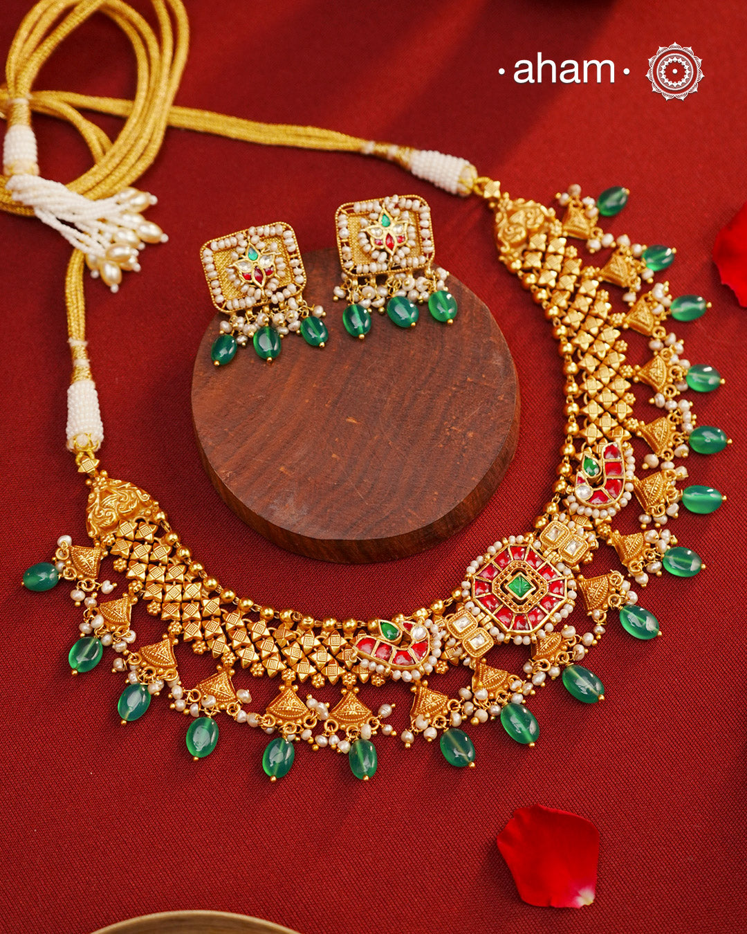 This Kundan Pearl Gold Polish Silver Neckpiece  Earrings Set from our Heritage collection showcases intricate traditional designs, meticulously crafted in 92.5 silver with a stunning gold polish and exquisite kundan work. Perfect for modern brides seeking a touch of timeless elegance.