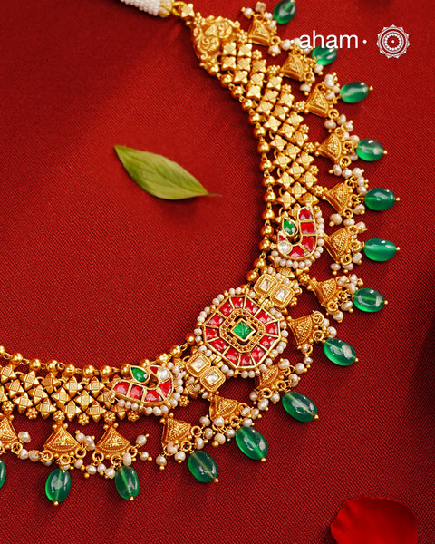 This Kundan Pearl Gold Polish Silver Neckpiece  Earrings Set from our Heritage collection showcases intricate traditional designs, meticulously crafted in 92.5 silver with a stunning gold polish and exquisite kundan work. Perfect for modern brides seeking a touch of timeless elegance.