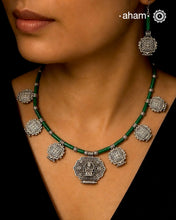 A beautiful neckpiece that we have made using vintage pieces that are inspired from Himalayan jewellery from the regions of nepal and tibet. 
The shapes are inspired from the mandala Ga'u forms with Intricate patterns,  and they are interspersed with malachite beads and small silver beads that have intricate detailing on them. The center pendant depicts Goddess Tara. 
Extremely fine workmanship and one of a kind piece. 