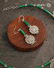 A beautiful neckpiece that we have made using vintage pieces that are inspired from Himalayan jewellery from the regions of nepal and tibet. 
The shapes are inspired from the mandala Ga'u forms with Intricate patterns,  and they are interspersed with malachite beads and small silver beads that have intricate detailing on them. The center pendant depicts Goddess Tara. 
Extremely fine workmanship and one of a kind piece. 