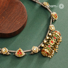 Expertly crafted in 92.5% silver, the Noori Dual Tone Silver Neckpiece &amp; Earrings Set blends traditional South Indian amulet design with contemporary elegance. Featuring intricate kemp work and gold polish at its center, the set is adorned with multiple small silver amulets along the chain and delicate pearl highlights. This dual-tone ensemble offers a refined balance of heritage and modernity, making it a timeless addition to any collection.