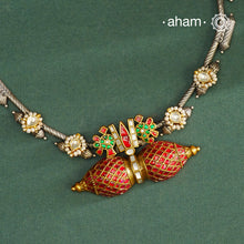 Expertly crafted in 92.5% silver, the Noori Dual Tone Silver Neckpiece &amp; Earrings Set blends traditional South Indian amulet design with contemporary elegance. Featuring intricate kemp work and gold polish at its center, the set is adorned with multiple small silver amulets along the chain and delicate pearl highlights. This dual-tone ensemble offers a refined balance of heritage and modernity, making it a timeless addition to any collection.