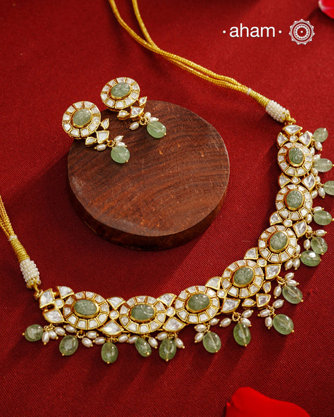 Experience the brilliance of the Moissanite Gold Polish Silver Neckpiece & Earrings Set, expertly crafted in 92.5% silver with a refined gold polish. This set features moissanite stones that closely mimic the sparkle of real diamonds, elegantly strung on green beads for a sophisticated look. Perfect for adding timeless elegance to any ensemble, it combines classic design with exquisite craftsmanship.