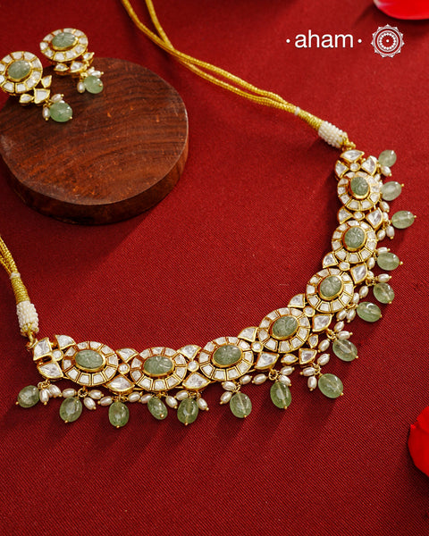 Experience the brilliance of the Moissanite Gold Polish Silver Neckpiece &amp; Earrings Set, expertly crafted in 92.5% silver with a refined gold polish. This set features moissanite stones that closely mimic the sparkle of real diamonds, elegantly strung on green beads for a sophisticated look. Perfect for adding timeless elegance to any ensemble, it combines classic design with exquisite craftsmanship.