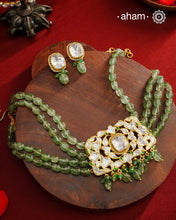 Experience the brilliance of the Moissanite Gold Polish Silver Neckpiece &amp; Earrings Set, expertly crafted in 92.5% silver with a refined gold polish. This set features moissanite stones that closely mimic the sparkle of real diamonds, elegantly strung on natural green aventurine stones for a sophisticated look. Perfect for adding timeless elegance to any ensemble, it combines classic design with exquisite craftsmanship.