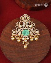 Crafted in 92.5 sterling silver with an elegant gold polish finish, this pendant and earring set features sparkling moissanite stones surrounding a lustrous green centre stone. Timeless yet striking, it is designed to add effortless sophistication to special occasions.