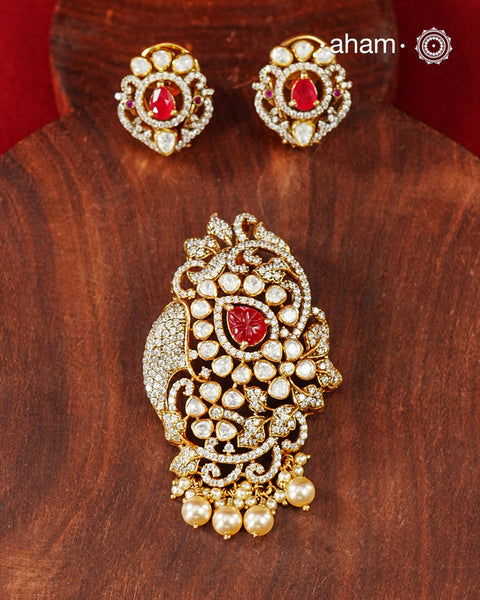 An exquisite composition of sparkling moissanites arranged around a vivid ruby-hued center, creating a pendant earring set that feels both timeless and striking. Crafted in 92.5 silver with gold polish, the piece draws inspiration from traditional Indian jewellery while remaining easy to style for modern celebrations.