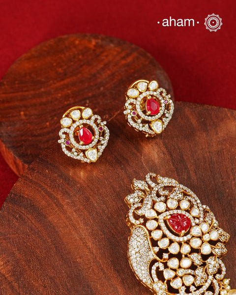 An exquisite composition of sparkling moissanites arranged around a vivid ruby-hued center, creating a pendant earring set that feels both timeless and striking. Crafted in 92.5 silver with gold polish, the piece draws inspiration from traditional Indian jewellery while remaining easy to style for modern celebrations.