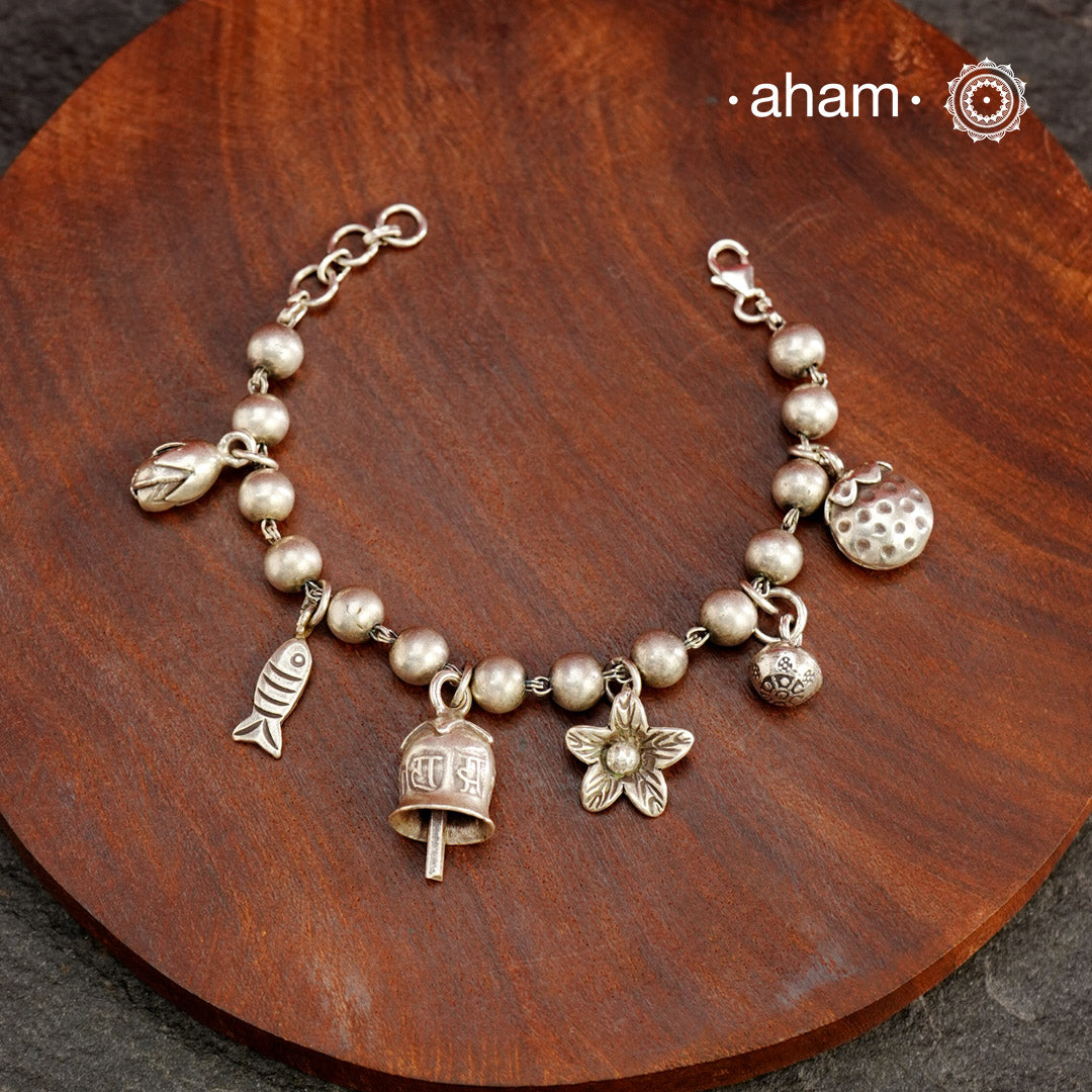 Up your wrist game with the A.M P.M Silver bracelet!
6 beautiful distinct charms all crafted in 92.5 silver come together to make this piece .Whether worn at day or night, this bracelet is Perfect for adding a playful touch to any outfit.