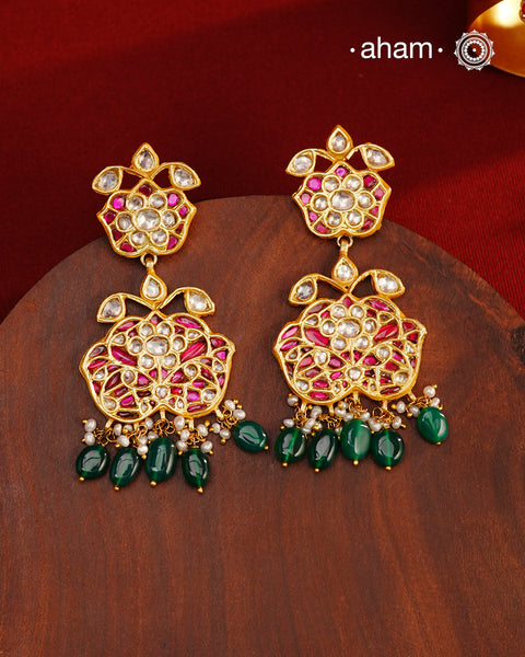 These intricately designed silver earrings are adorned with radiant Kundan, vibrant Kemp, and gleaming Emeralds, all beautifully complemented by lustrous Pearls. Finished with a luxurious Gold Polish, these earrings exude timeless elegance and are a must-have addition to any jewellery collection. Perfect for weddings, festive occasions, or adding a touch of heritage charm to your everyday look.
