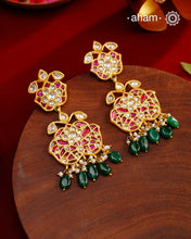 These intricately designed silver earrings are adorned with radiant Kundan, vibrant Kemp, and gleaming Emeralds, all beautifully complemented by lustrous Pearls. Finished with a luxurious Gold Polish, these earrings exude timeless elegance and are a must-have addition to any jewellery collection. Perfect for weddings, festive occasions, or adding a touch of heritage charm to your everyday look.