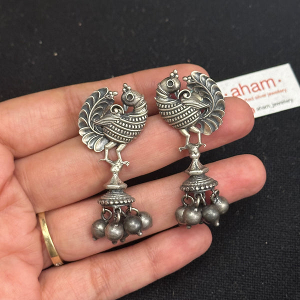 Handcrafted pair of Nrityam earrings in 92.5 sterling silver with intircate peacock and a beautiful jhumkie. 