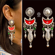 Crafted with precision, these Rang Mahal Silver Earrings feature a unique red drop design with a fish motif. Combining 92.5 sterling silver with vibrant colored glass creates a magical, eye-catching accessory.