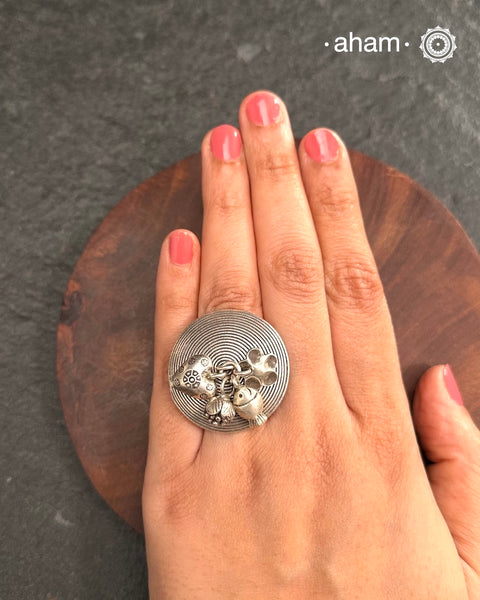 Adjustable Ring in 92.5 sterling silver with different charms.Perfect piece to add a playful touch to your look.