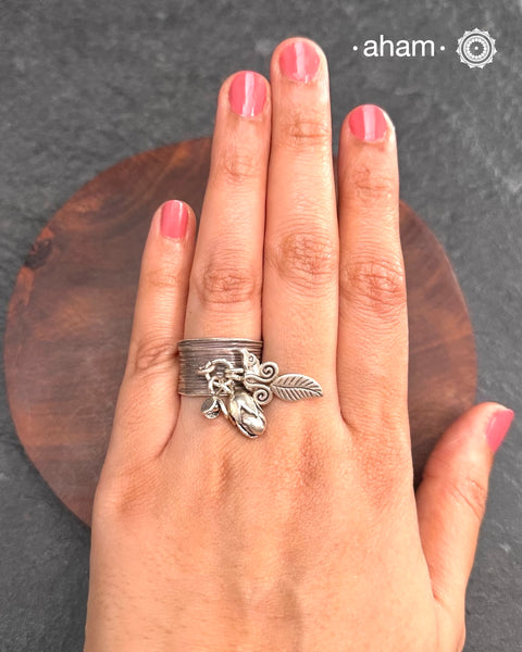 Adjustable Ring in 92.5 sterling silver with different charms.Perfect piece to add a playful touch to your look.