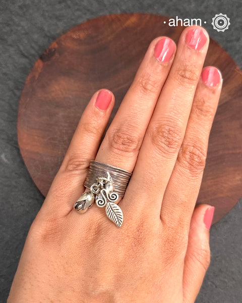 Adjustable Ring in 92.5 sterling silver with different charms.Perfect piece to add a playful touch to your look.