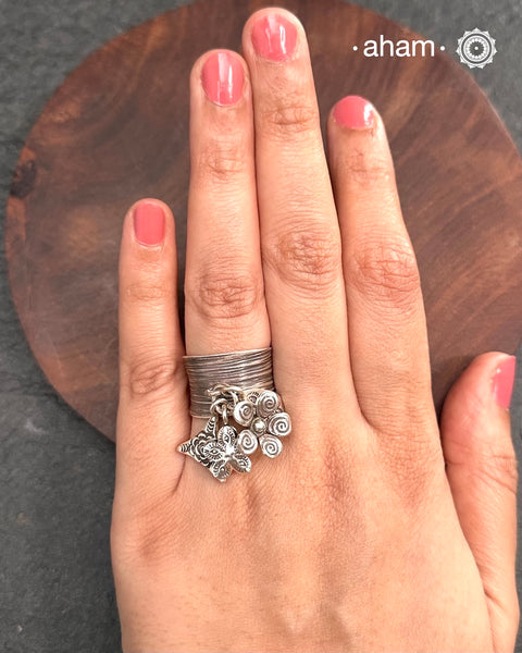 Adjustable Ring in 92.5 sterling silver with different charms.Perfect piece to add a playful touch to your look.