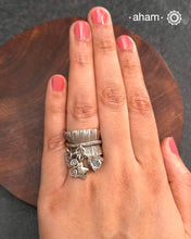 Adjustable Ring in 92.5 sterling silver with different charms. Perfect piece to add a playful touch to your look.