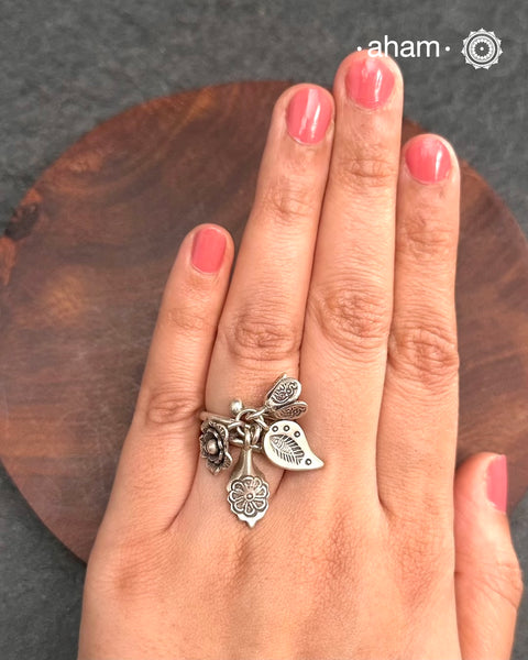 Adjustable Ring in 92.5 sterling silver with different charms.Perfect piece to add a playful touch to your look.