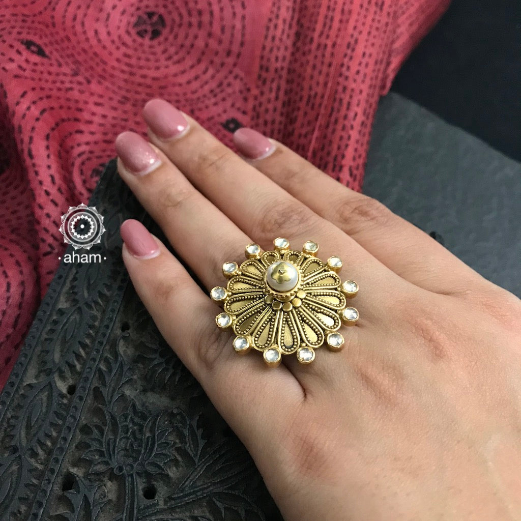 Festive gold polish adjustable ring including elegant kundan work. Handcrafted in 92.5 sterling silver with cultured pearl crown. Perfect for special occasions and festivities. 