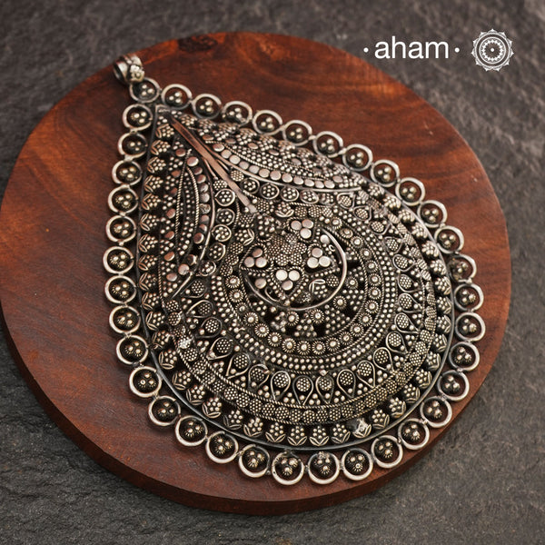 Expertly crafted in 92.5 silver, the Mewad Silver Pendant features intricate tar and rava work, making it a stunning statement piece. Elevate your look with this versatile pendant that exudes elegance and style. (Does not include chain)