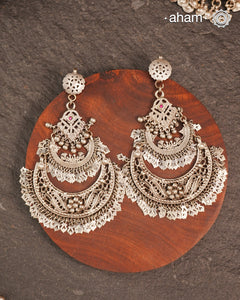 These Statement Silver Chandbali Earrings feature a bold, large design that commands attention. Expertly crafted in silver, they combine traditional crescent shapes with a contemporary edge, making them ideal for elevating your look with a sophisticated yet striking accessory. Perfect for those who value both craftsmanship and standout style.