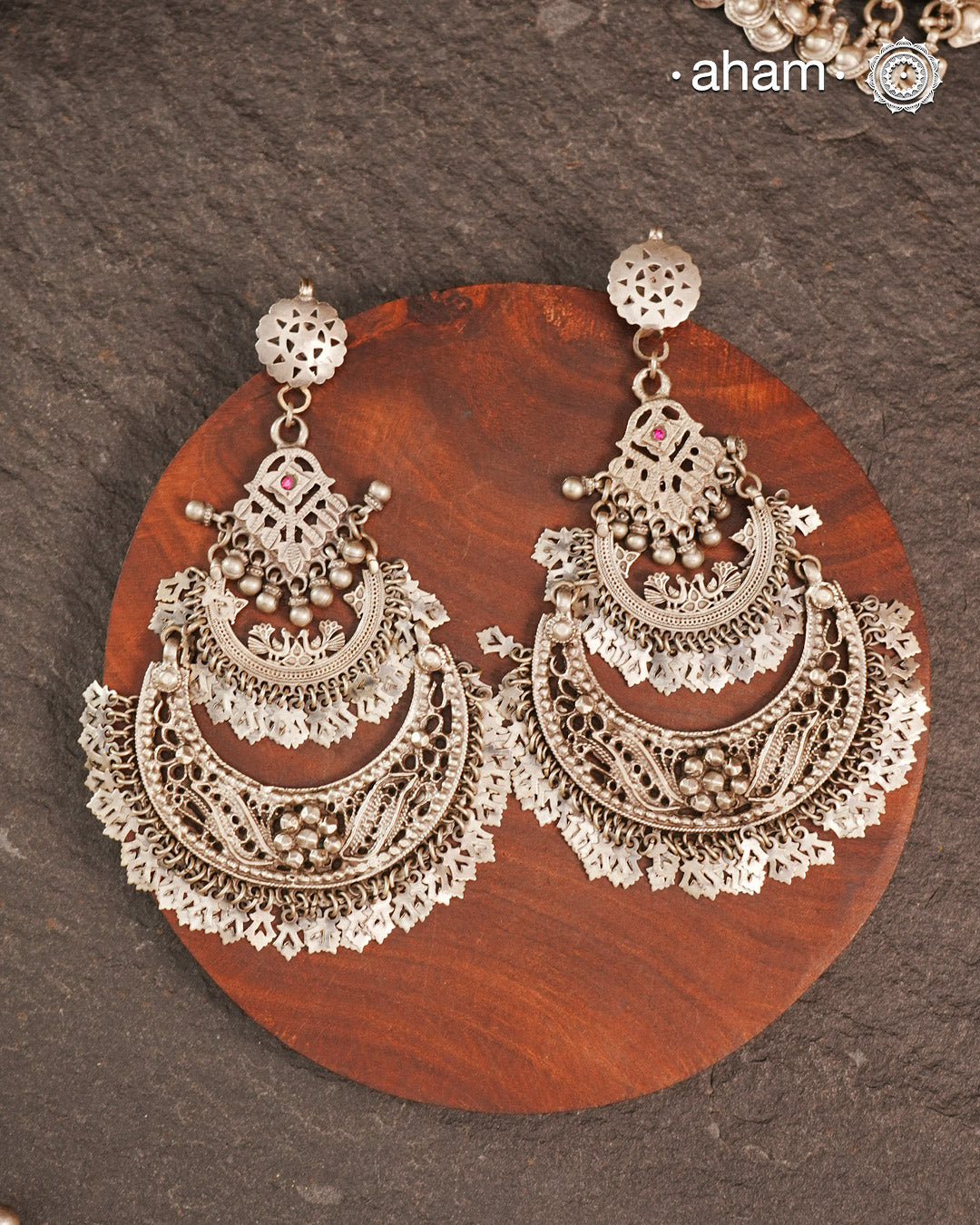 These Statement Silver Chandbali Earrings feature a bold, large design that commands attention. Expertly crafted in silver, they combine traditional crescent shapes with a contemporary edge, making them ideal for elevating your look with a sophisticated yet striking accessory. Perfect for those who value both craftsmanship and standout style.