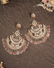 These Statement Silver Chandbali Earrings feature a bold, large design that commands attention. Expertly crafted in silver, they combine traditional crescent shapes with a contemporary edge, making them ideal for elevating your look with a sophisticated yet striking accessory. Perfect for those who value both craftsmanship and standout style.