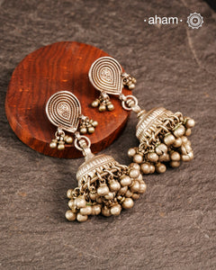 These Tribal Silver Jhumkie earrings showcase expert craftsmanship with finely detailed silver work and beautifully rhythmic ghungroos that add a gentle, melodic charm. Perfect for enhancing traditional attire or adding an ethnic touch to modern outfits, they embody cultural heritage with elegance and sophistication.