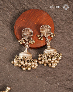 These Tribal Silver Jhumkie earrings showcase expert craftsmanship with finely detailed silver work and beautifully rhythmic ghungroos that add a gentle, melodic charm. Perfect for enhancing traditional attire or adding an ethnic touch to modern outfits, they embody cultural heritage with elegance and sophistication.