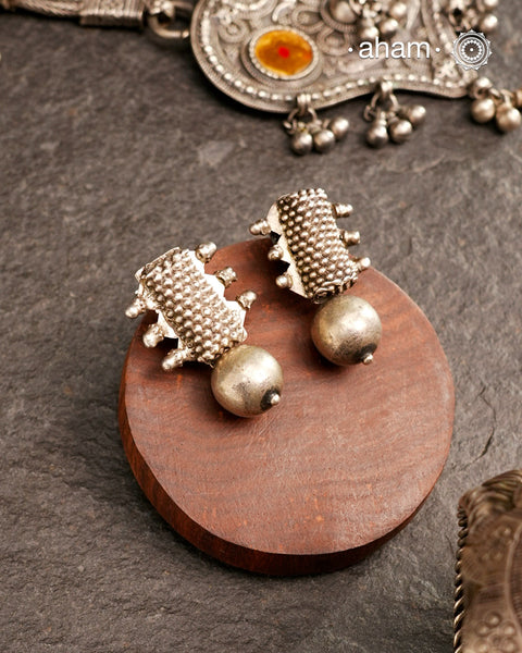 An exquisite fusion of the past and present, these Vintage Tribal Earrings unite two stunning silver pieces. The top features vintage amulets steeped in history, while the bottom showcases a beautiful bead. Handcrafted in silver, this unique piece is a must-have for those who cherish tribal heritage jewellery with a story to tell.