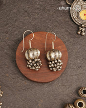 Stunning pumpkin bead earring with ghungroos at the bottom. Handcrafted in silver, this unique piece is a must-have for those who cherish tribal heritage jewellery with a story to tell.