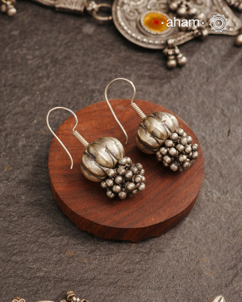 Stunning pumpkin bead earring with ghungroos at the bottom. Handcrafted in silver, this unique piece is a must-have for those who cherish tribal heritage jewellery with a story to tell.