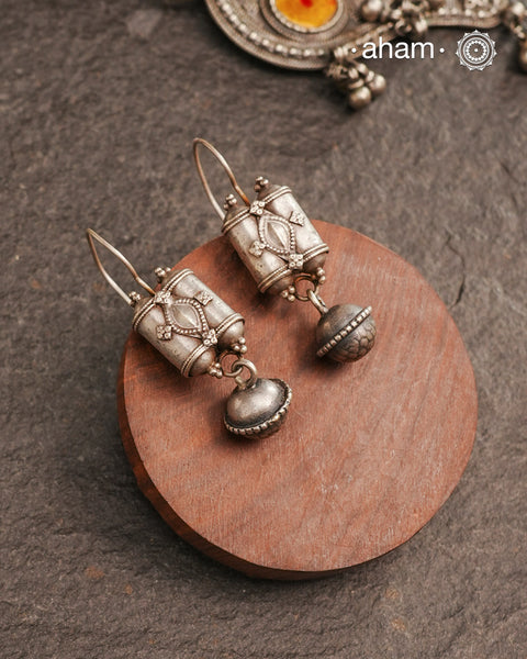 An exquisite fusion of the past and present, these Vintage Tribal Earrings unite two stunning silver pieces. The top features vintage amulets steeped in history, while the bottom showcases a beautiful bead. Handcrafted in Silver, this unique piece is a must-have for those who cherish tribal heritage jewellery with a story to tell.